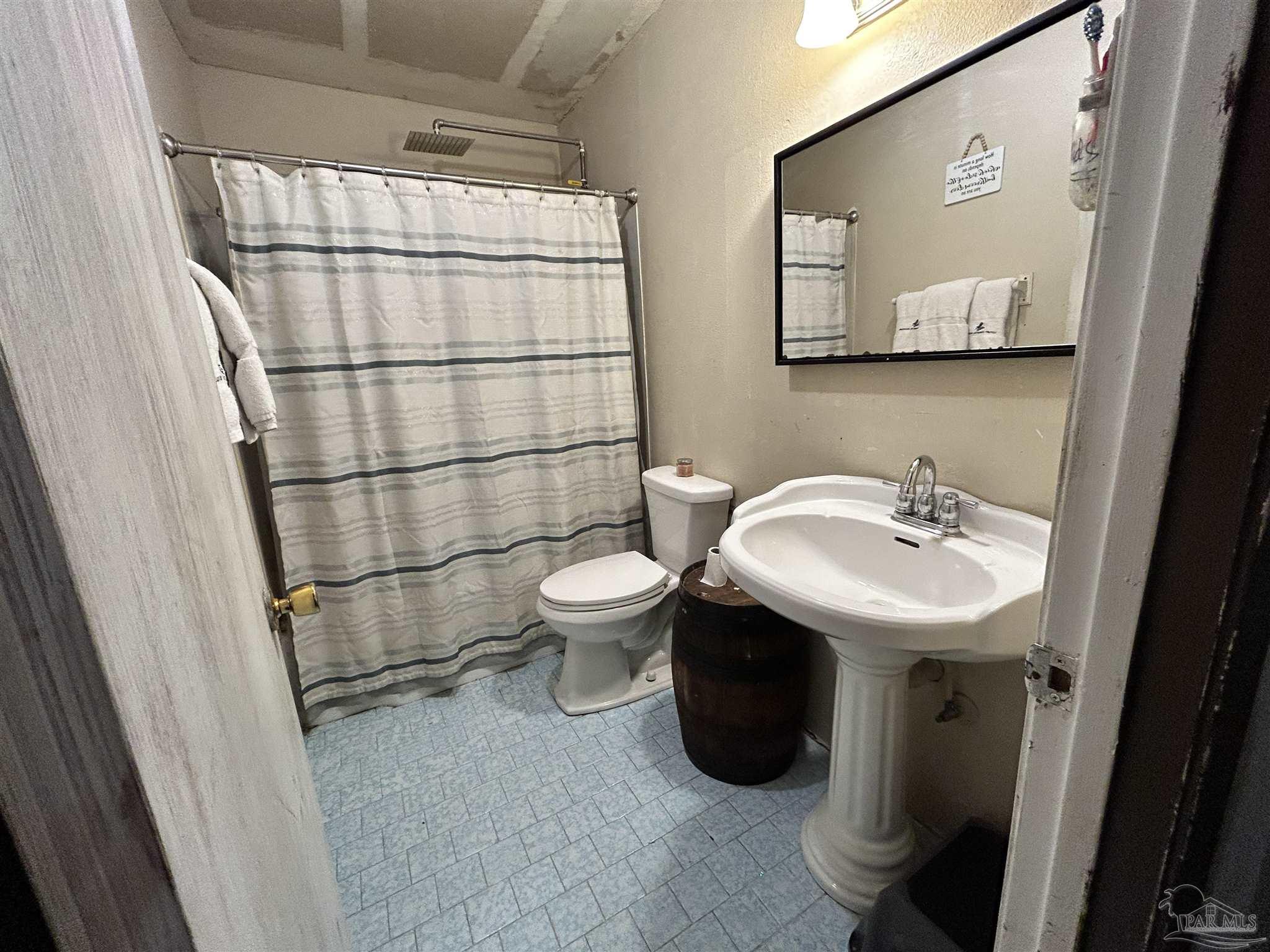 10246 Nichols Lake Road Milton, FL 32583 - Photo 26 of 43 a bathroom with a sink toilet and shower