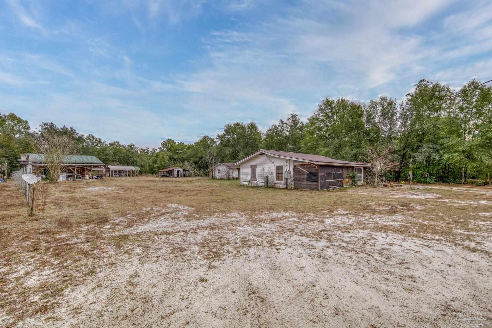 10246 Nichols Lake Road Milton, FL 32583 - Photo 38 of 43 a view of a house with a yard
