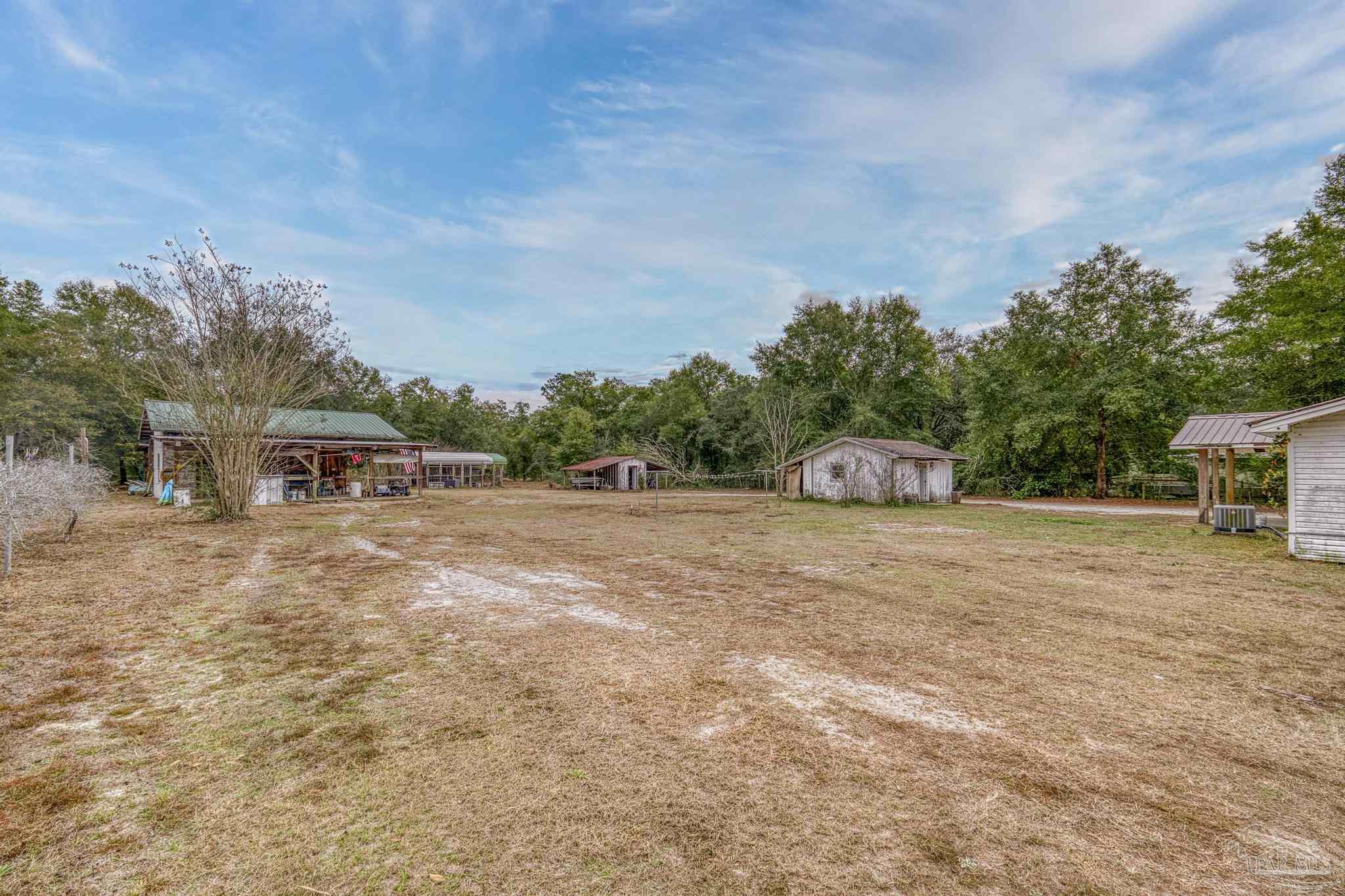 10246 Nichols Lake Road Milton, FL 32583 - Photo 39 of 43 a pathway of a house with a yard