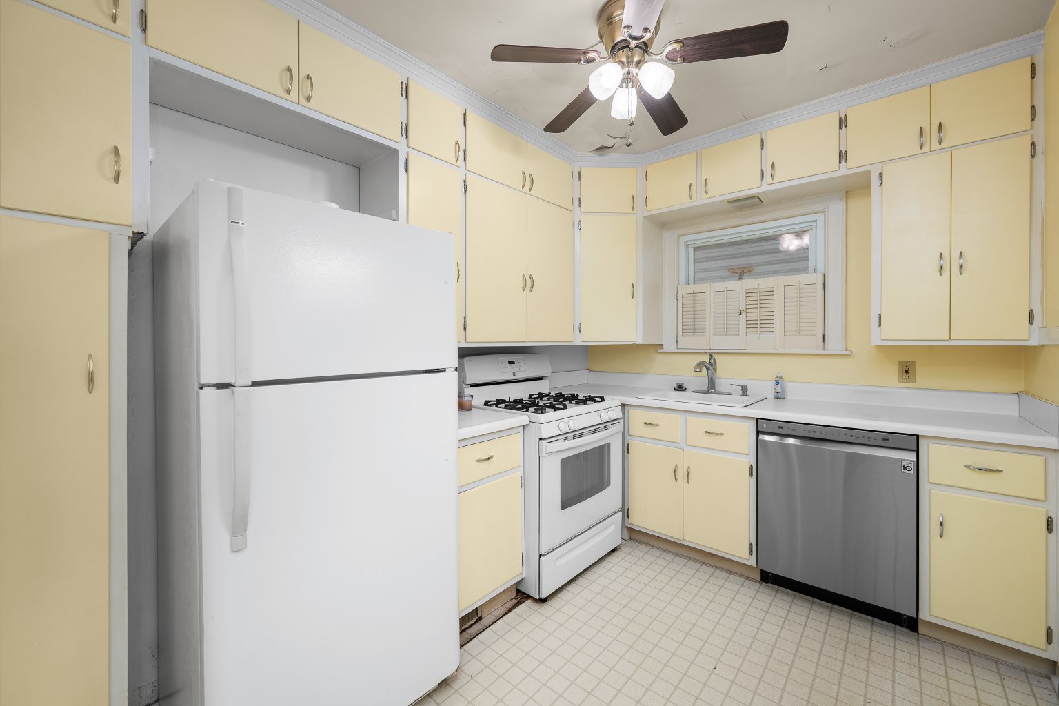 925 24th Street Moline, IL 61265 - Photo 12 of 37 a kitchen with stainless steel appliances granite countertop a refrigerator a sink a stove and white cabinets