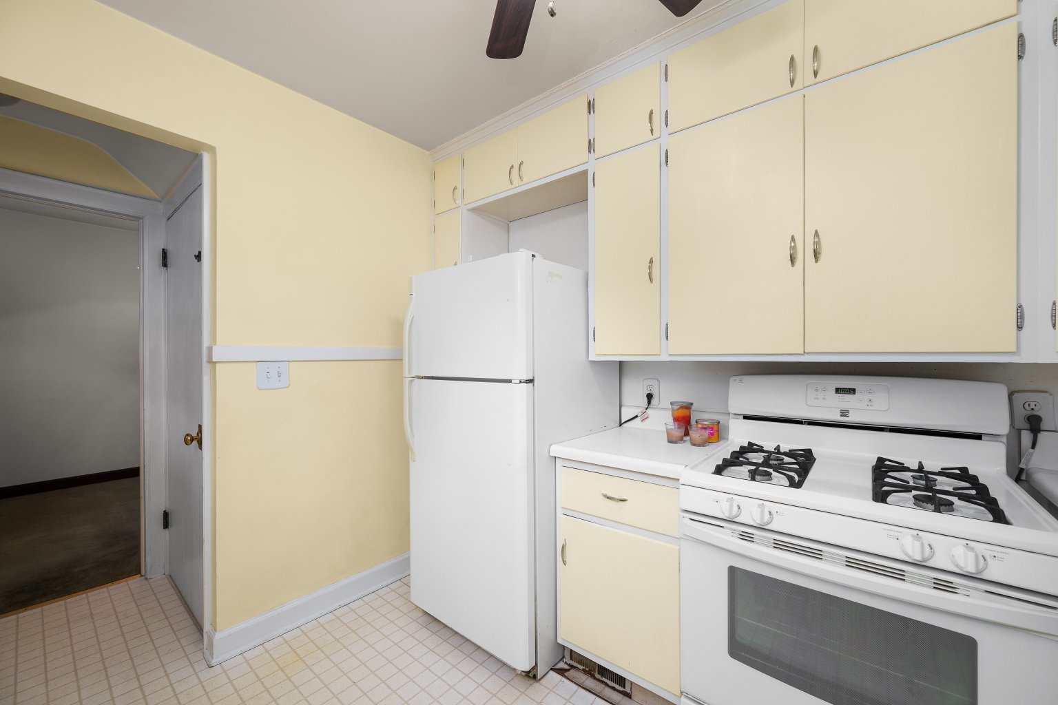 925 24th Street Moline, IL 61265 - Photo 14 of 37 a kitchen with refrigerator and cabinets