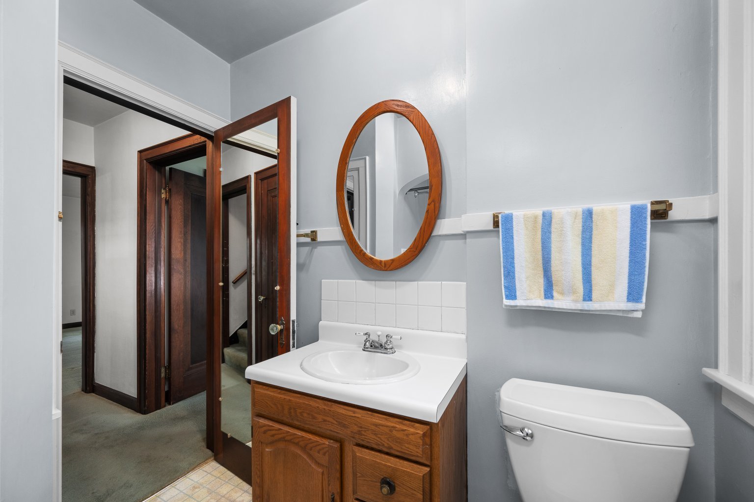 925 24th Street Moline, IL 61265 - Photo 19 of 37 a bathroom with a toilet a sink and a mirror