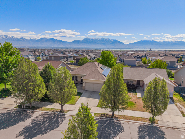 7092 Cherokee Street Eagle Mountain, UT 84005 - Photo 1 of 27 Single-story residence with an attached garage, featuring solar panels on the roof