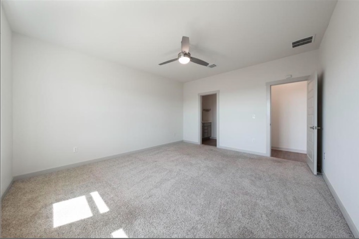 10805 Meris Lane Austin, TX 78754 - Photo 14 of 28 Well-lit and spacious, this bedroom features soft carpeting and convenient access to a private walk-in closet.