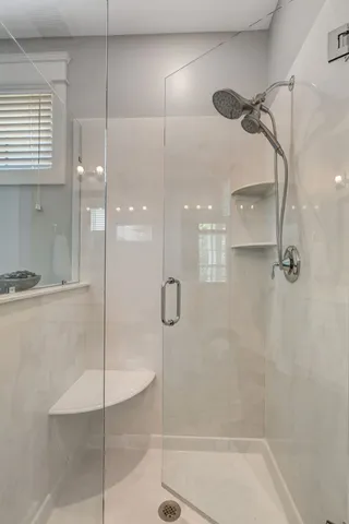 a bathroom with a tub sink and mirror