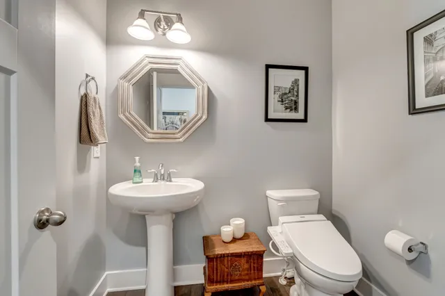 a view of a hallway with wooden floor and furniture