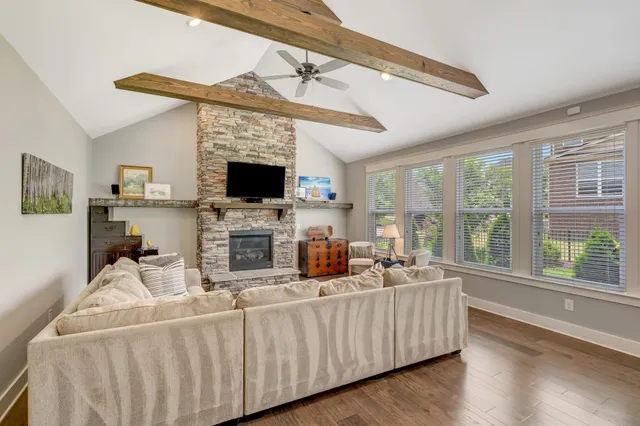 a living room with furniture a flat screen tv and a fireplace