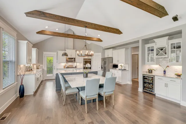 a kitchen with stainless steel appliances granite countertop a sink a stove and a wooden floors