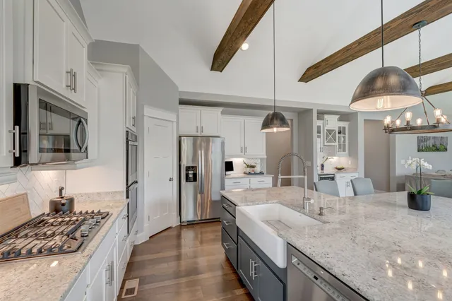 a kitchen with a sink appliances and cabinets