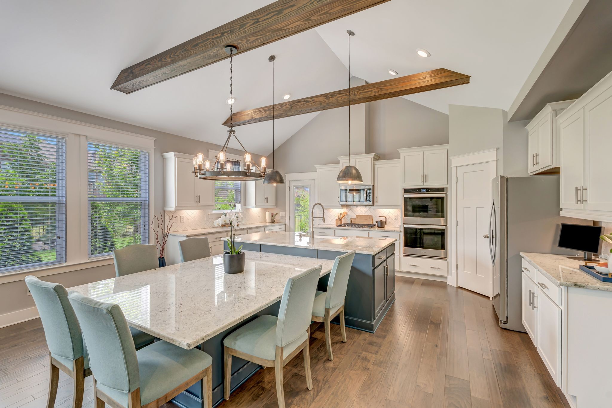 607 Beamon Drive Franklin, TN 37064 - Photo 30 of 45 a dining room with stainless steel appliances kitchen island granite countertop a table chairs and a refrigerator
