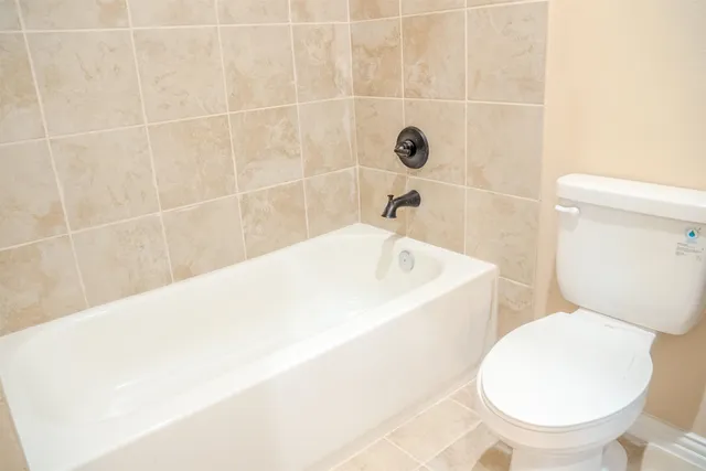 a white bath tub sitting next to a white toilet