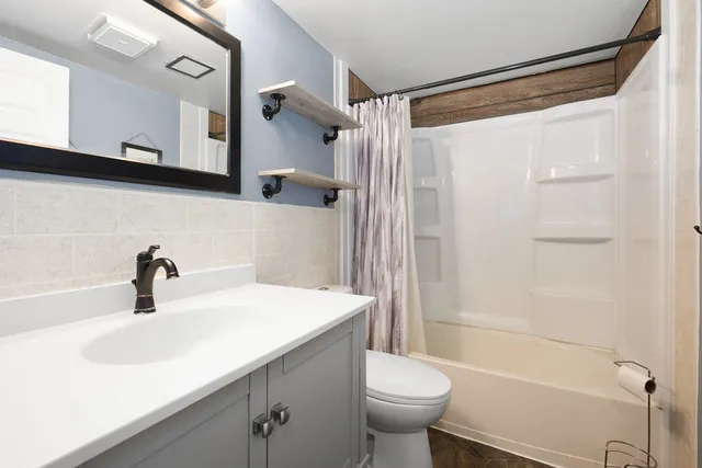 a bathroom with a sink a toilet and a bathtub