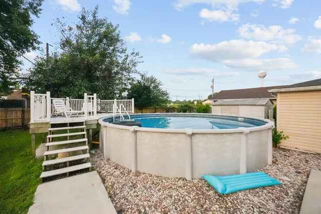 a view of a backyard with a garden and trees