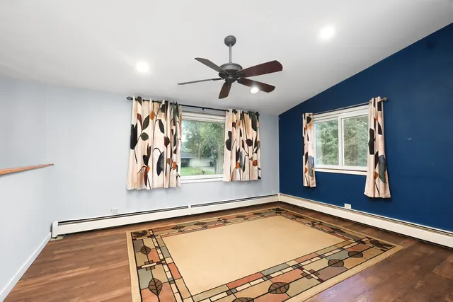 a living room with blue floor pool table and a window