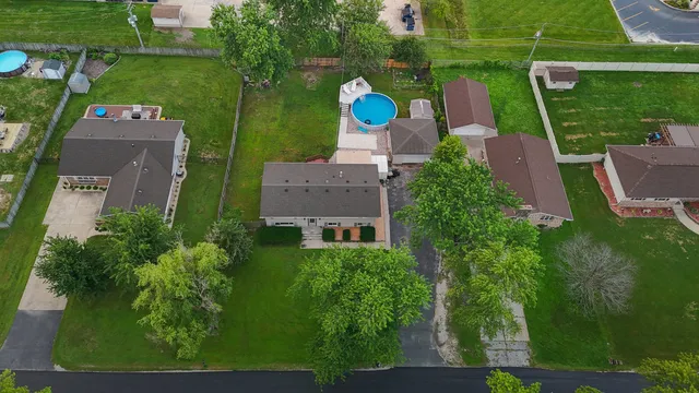 an aerial view of house with yard swimming pool and outdoor seating
