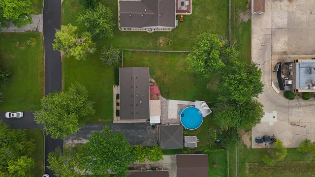 an aerial view of a house with garden space and street view