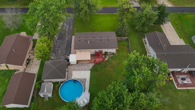 an aerial view of a house with outdoor space and street view
