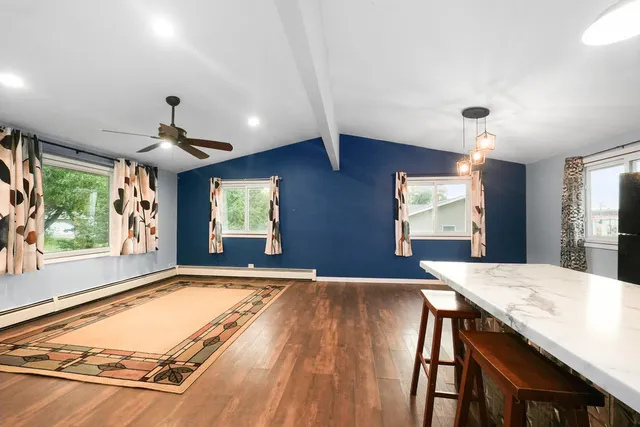 a view of kitchen and dining room with wooden floor