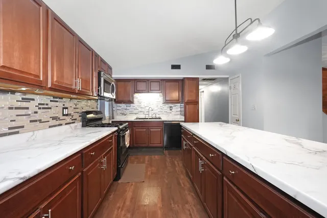 a kitchen with a sink stove top oven and cabinets