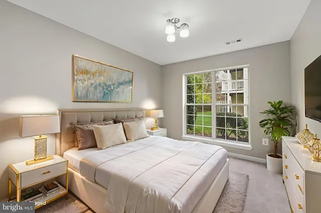 a bedroom with a large bed and a window