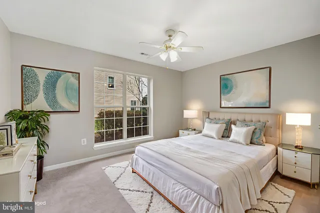 a bedroom with a large bed and a window