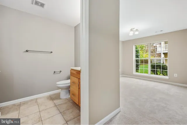 a bathroom with a toilet a sink and a window