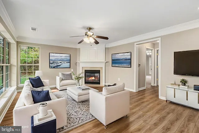 a living room with furniture flat screen tv and a fireplace
