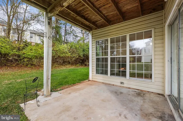 a view of a house with backyard and porch
