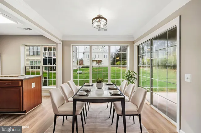 a view of a dining room with furniture large windows and wooden floor