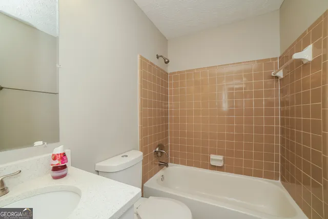 a bath room with a toilet and a bath tub