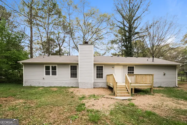 a house that has a tree in front of it