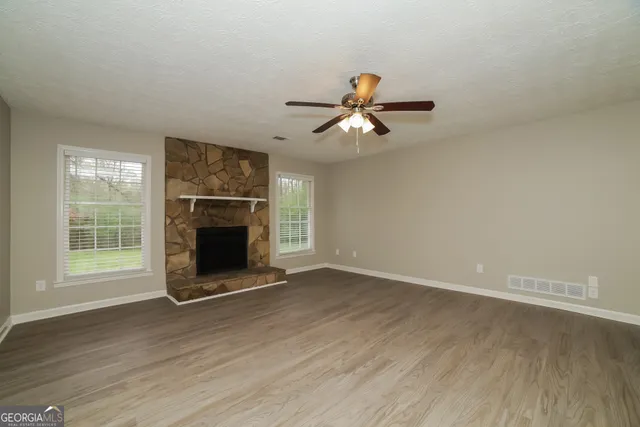 wooden floor in an empty room with a fireplace