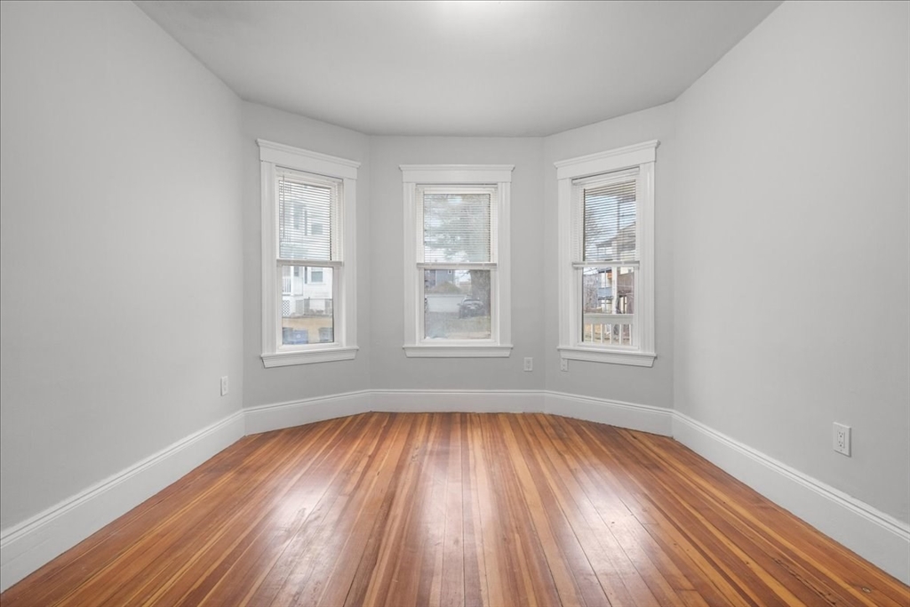4 Bailey Street, Unit 1 Boston, MA 02124 - Photo 3 of 11 wooden floor in an empty room with a window