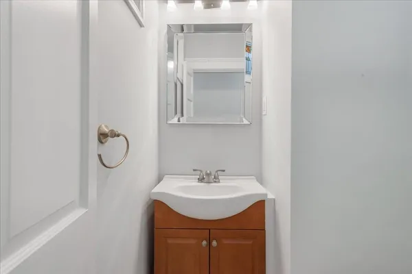 a bathroom with a sink vanity and a mirror