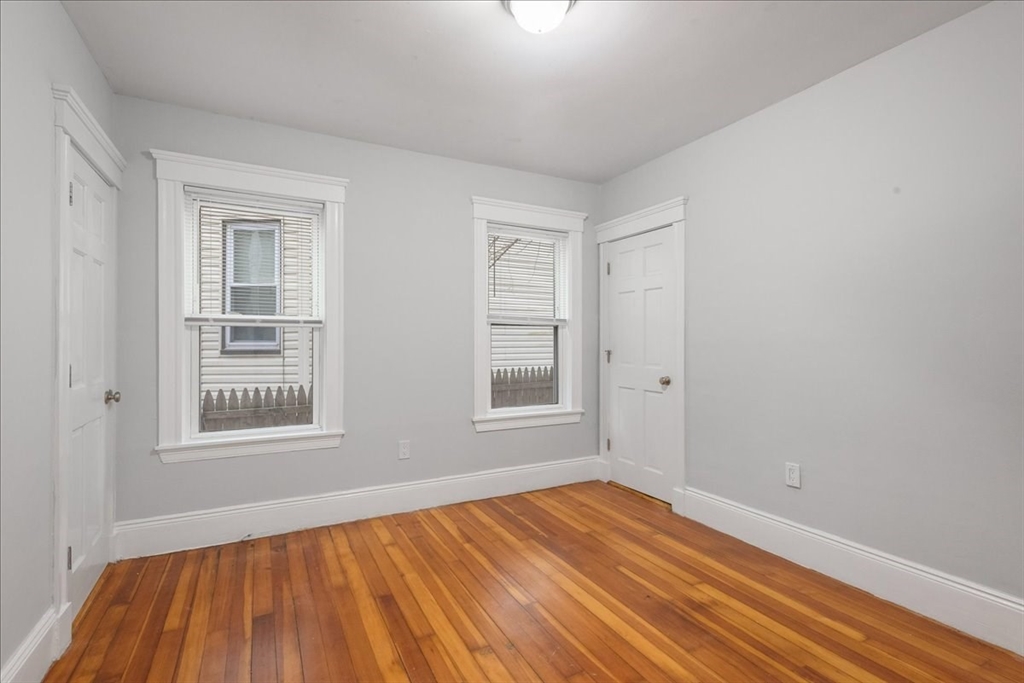 4 Bailey Street, Unit 1 Boston, MA 02124 - Photo 9 of 11 a view of an empty room with wooden floor and a window