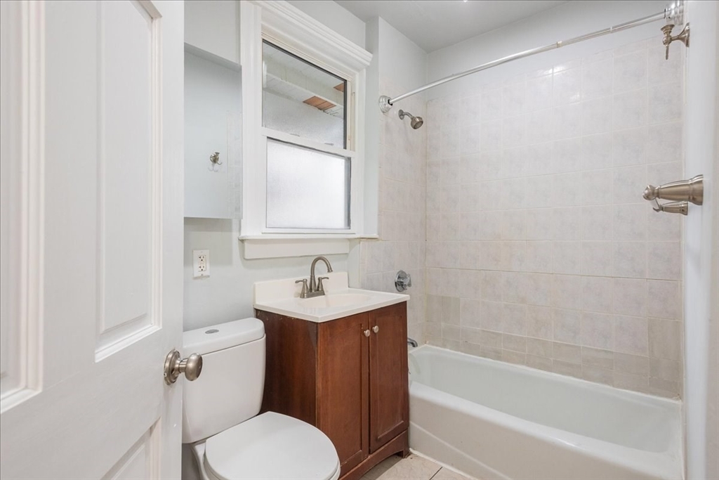 4 Bailey Street, Unit 1 Boston, MA 02124 - Photo 10 of 11 a bathroom with a sink a toilet and shower