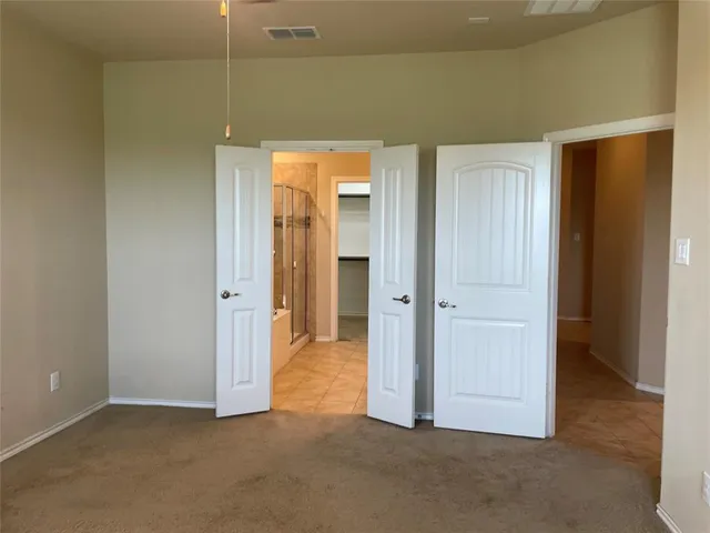 an empty room with closet and a bathroom