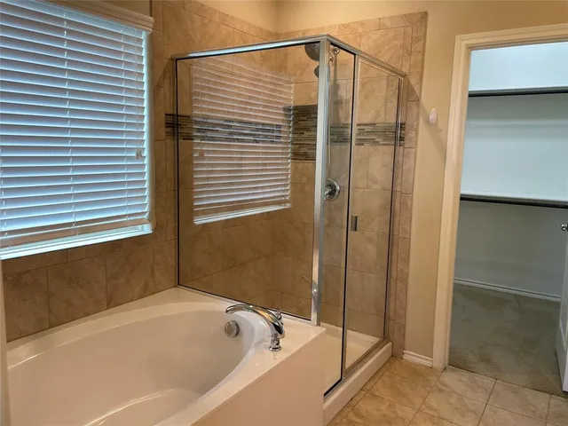 a bathroom with a bathtub and shower
