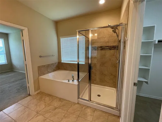 a bathroom with a tub and a shower