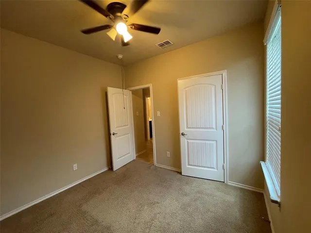 a view of a livingroom with a chandelier fan