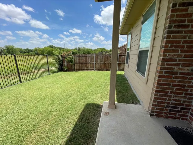 a view of a pathway with a wrought fence