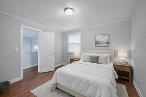 a bedroom with a bed and a painting on the wall