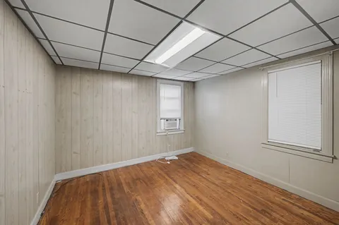 a view of empty room with wooden floor