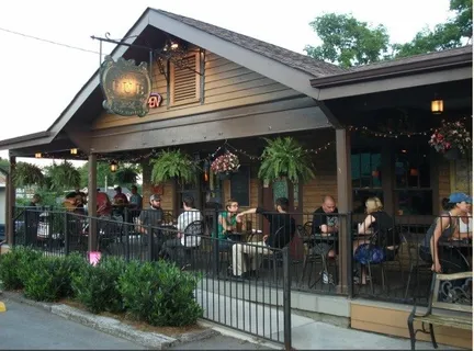 a view of a chairs and table in patio in front of a building
