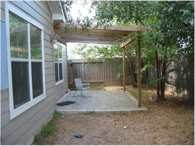 a view of backyard with green space and seating space