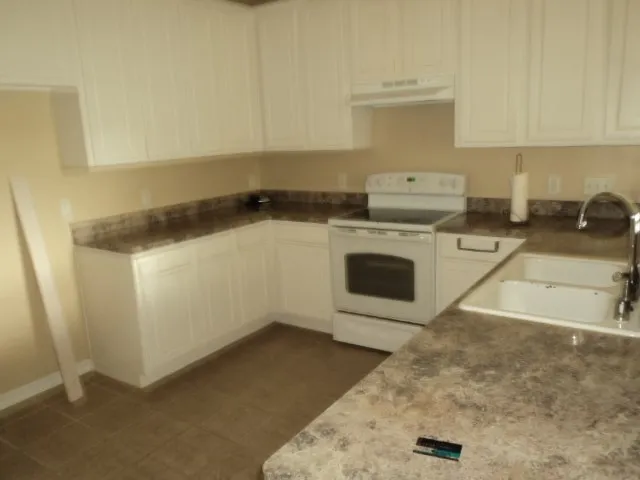 a kitchen with a stove and a sink