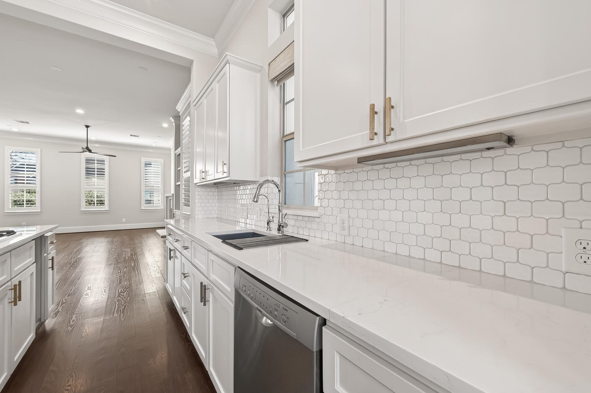 122 Gateway Park Place Spring, TX 77380 - Photo 22 of 44 Sunlit remodeled kitchen with crisp white cabinetry, quartz counters, oversized island, and a wine chiller.