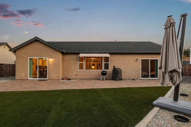 a view of a patio with table and chairs and potted plants