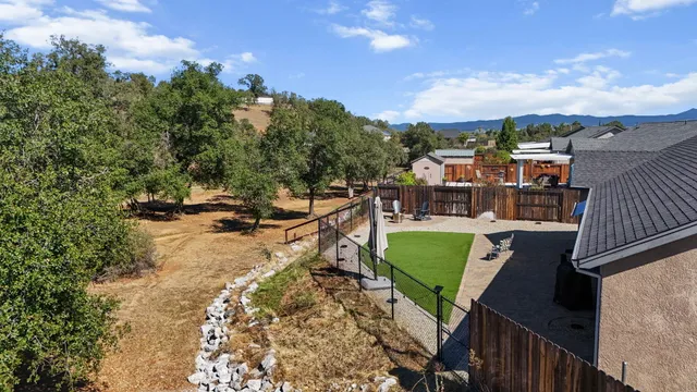 a view of a house with a patio and a garden