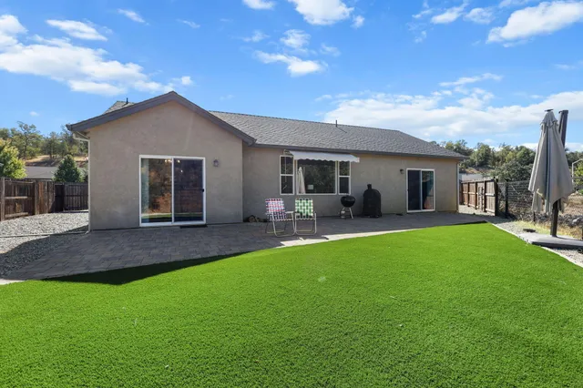 a view of yard with swimming pool and green space